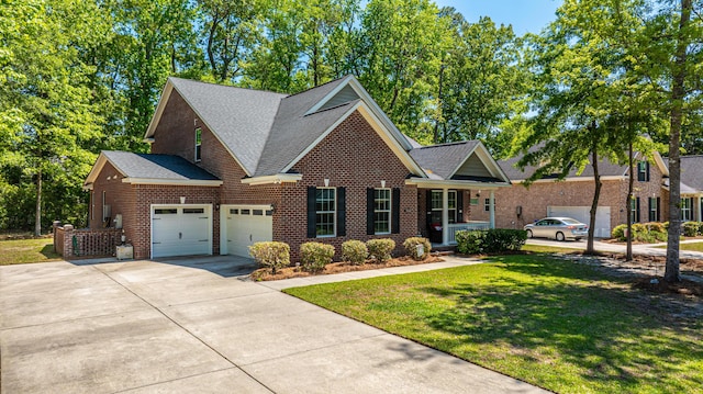 5442 Clearview Dr, North Charleston, SC 29420 - traditional-style house with an attached garage, brick siding, driveway, a front yard, and roof with shingles