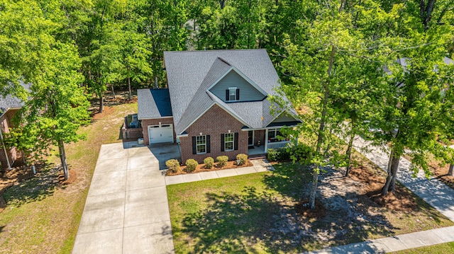 5442 Clearview Dr, North Charleston, SC 29420 - view of front of property with a porch, concrete driveway, roof with shingles, an attached garage, and brick siding