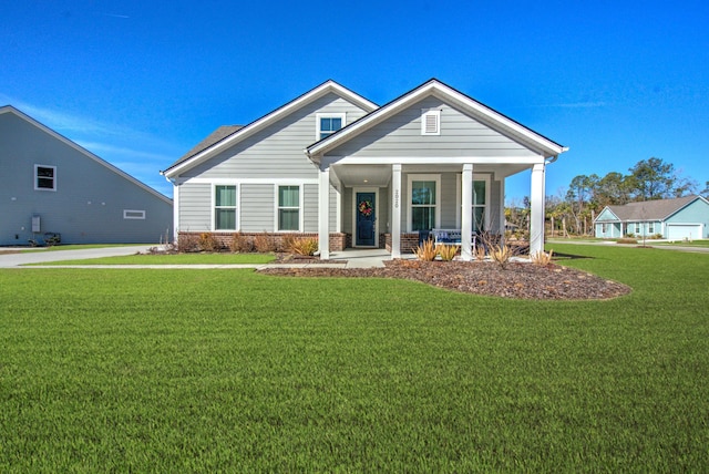 view of front of house with a porch and a front lawn