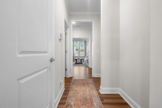 hall featuring dark wood-type flooring and ornamental molding