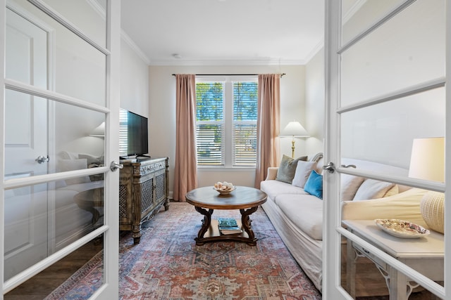 living room with crown molding, hardwood / wood-style floors, and french doors