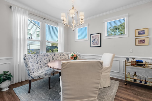 dining area featuring an inviting chandelier, crown molding, and dark hardwood / wood-style floors