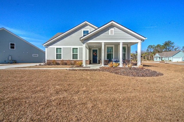 view of front of house featuring a porch and a front yard