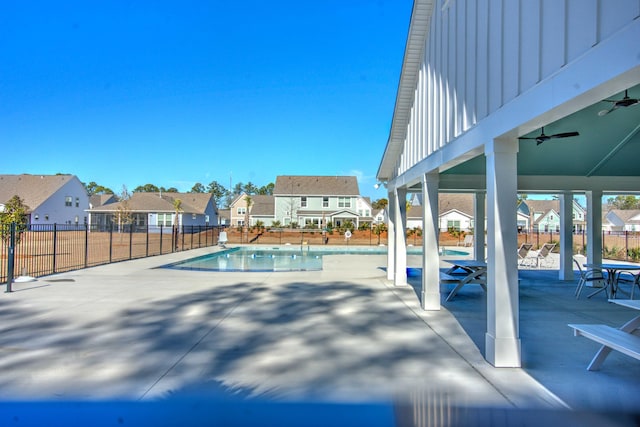 view of swimming pool with ceiling fan and a patio area