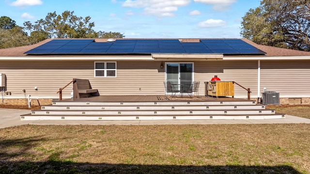 rear view of house with central AC, a yard, and a deck