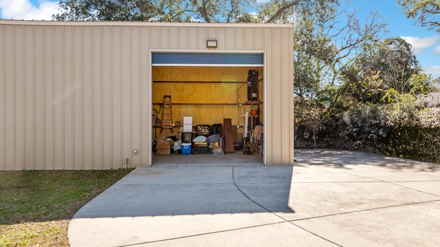 view of pole building featuring concrete driveway