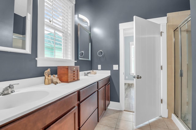full bathroom with healthy amount of natural light, a shower stall, and tile patterned floors