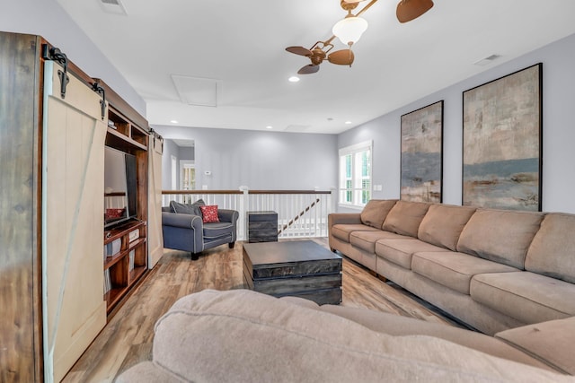 living area with wood finished floors, recessed lighting, and attic access