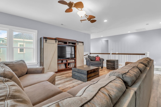 living area with wood finished floors, ceiling fan, and recessed lighting
