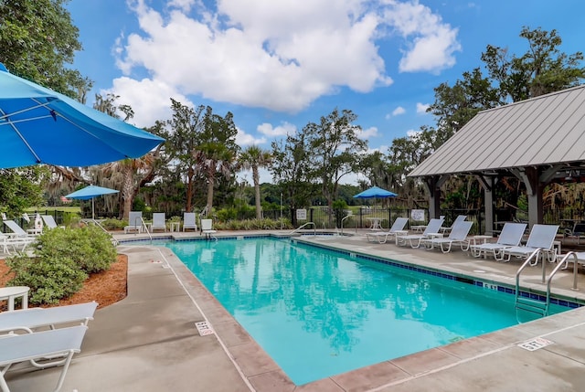 community pool featuring a patio area, fence, and a gazebo