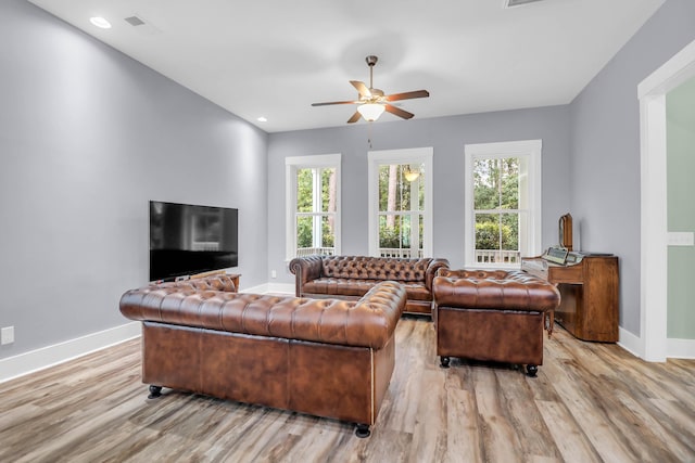 living area featuring wood finished floors, healthy amount of natural light, ceiling fan, and recessed lighting