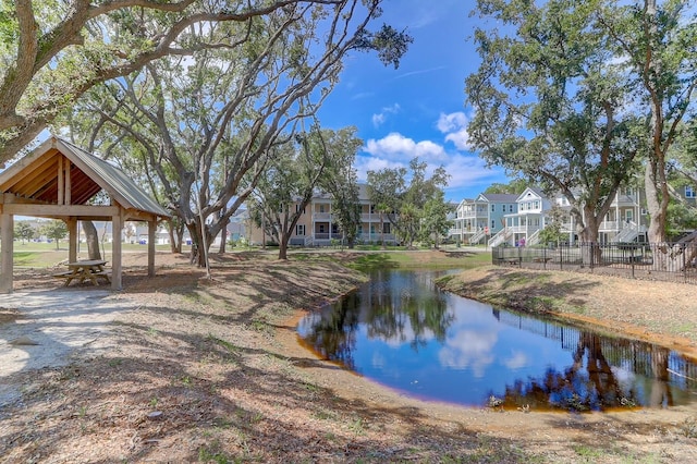 water view with nearby suburban area, fence, and a gazebo