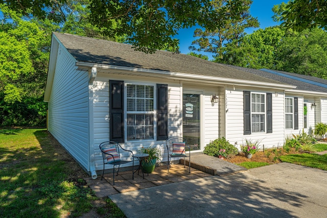 view of front of home with a shingled roof
