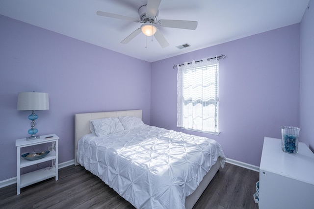 bedroom featuring wood finished floors, baseboards, and a ceiling fan