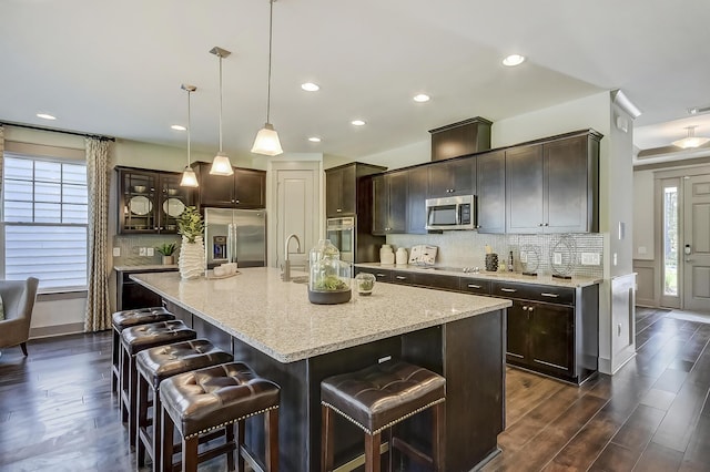 118 Magnolia House Dr, Summerville, SC 29486 - kitchen featuring appliances with stainless steel finishes, dark wood-type flooring, dark brown cabinets, decorative backsplash, and recessed lighting