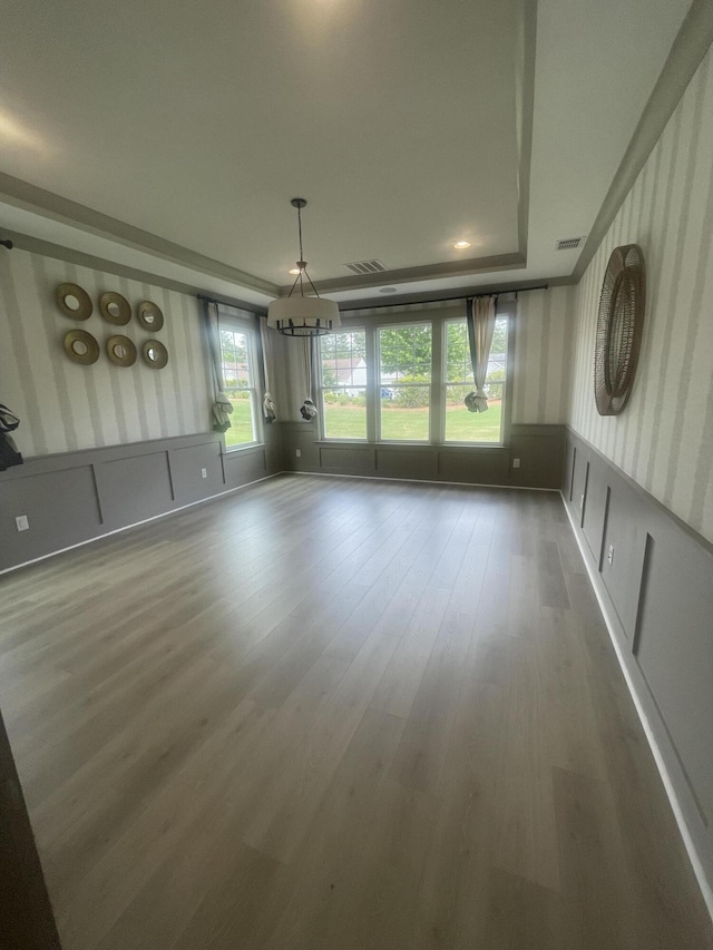 118 Magnolia House Dr, Summerville, SC 29486 - unfurnished dining area featuring a chandelier, wood finished floors, wallpapered walls, a wainscoted wall, and a tray ceiling