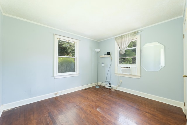 unfurnished room with hardwood / wood-style flooring, cooling unit, and crown molding