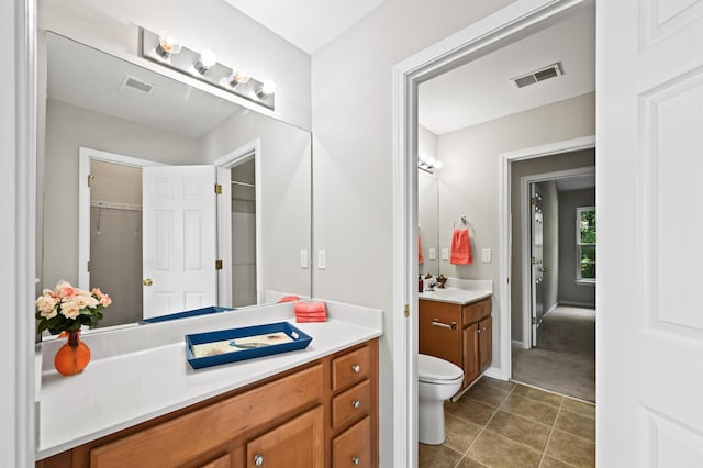 bathroom with tile patterned floors, vanity, and toilet