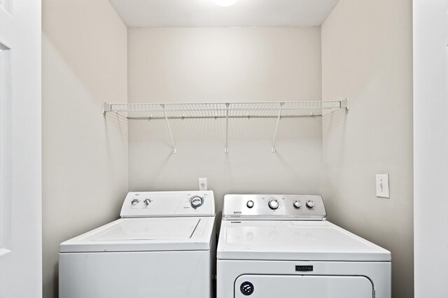 clothes washing area with washer and dryer