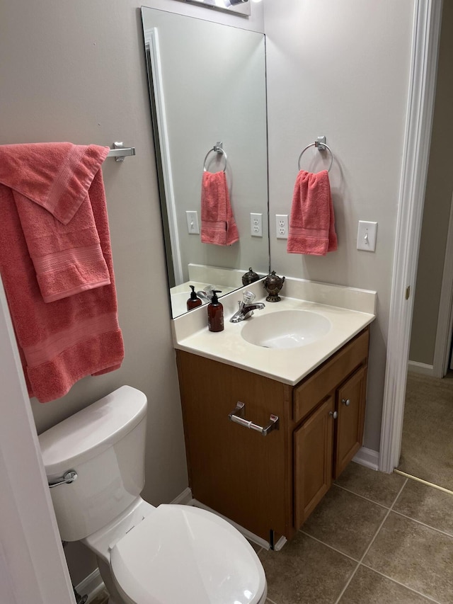 bathroom with vanity, toilet, and tile patterned flooring