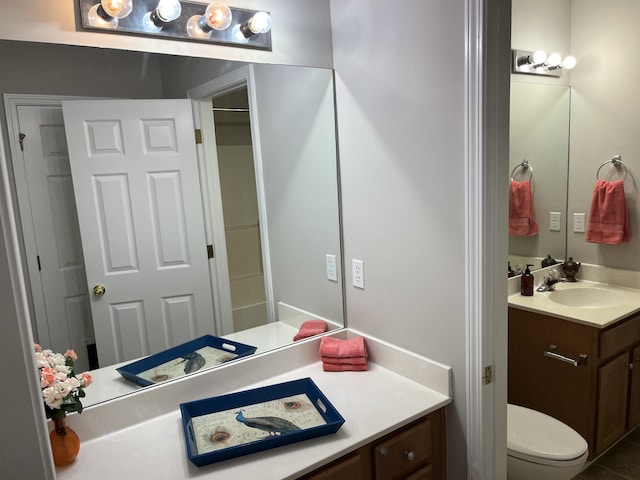 bathroom featuring tile patterned floors, vanity, and toilet