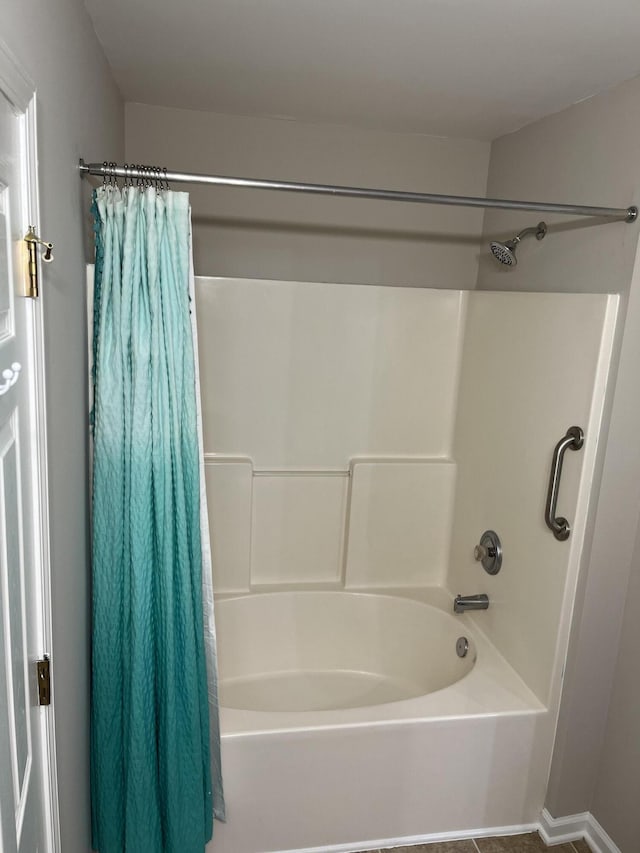 bathroom featuring shower / bath combination with curtain and tile patterned floors