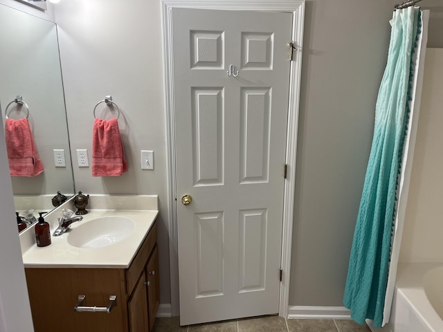 bathroom featuring tile patterned flooring, vanity, and shower / bathtub combination with curtain