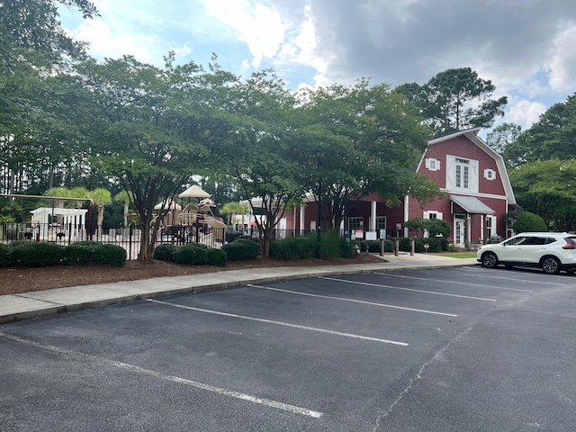 view of vehicle parking featuring a playground