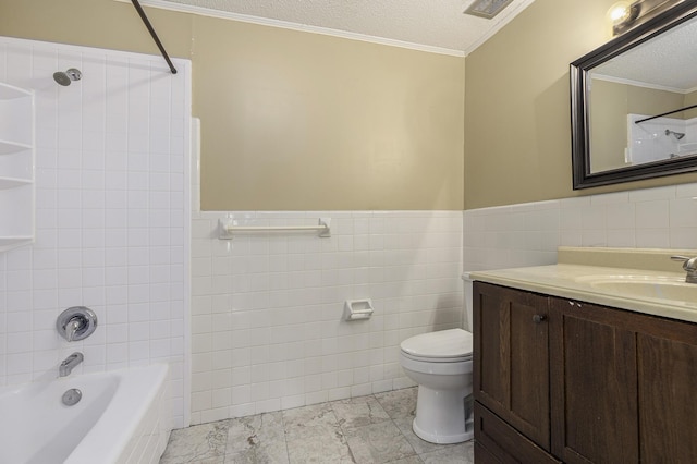 full bathroom with vanity, tiled shower / bath, toilet, ornamental molding, and a textured ceiling