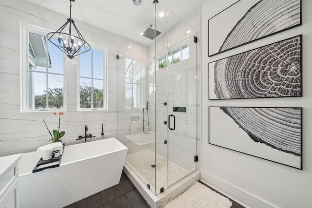 bathroom with a freestanding tub, a shower stall, plenty of natural light, and tile walls