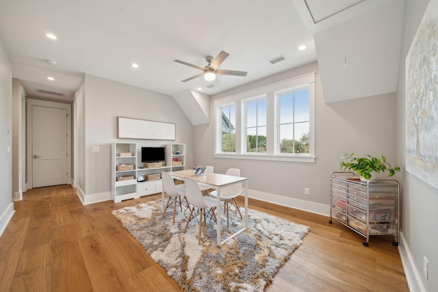 dining space featuring light wood-style floors, attic access, visible vents, and baseboards