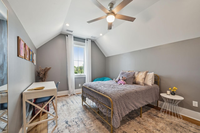 bedroom featuring lofted ceiling, baseboards, visible vents, and wood finished floors