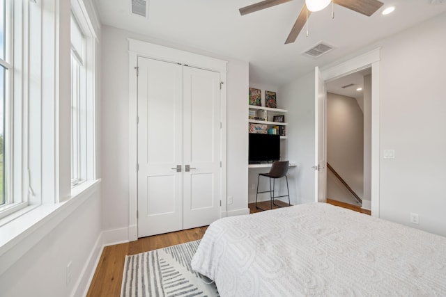 bedroom with light wood-type flooring, multiple windows, and visible vents