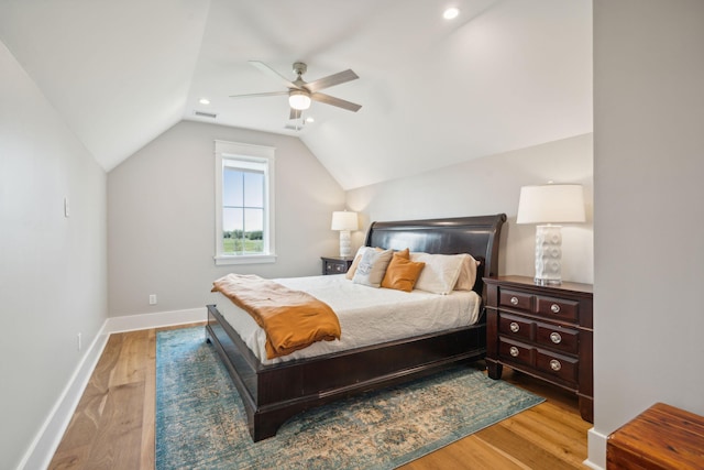 bedroom with visible vents, vaulted ceiling, ceiling fan, light wood-type flooring, and baseboards