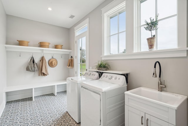 laundry room featuring recessed lighting, laundry area, a sink, visible vents, and washing machine and clothes dryer