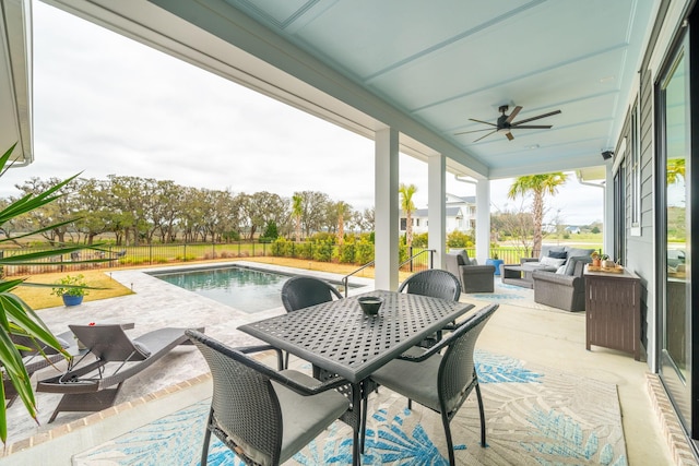 view of patio featuring ceiling fan, outdoor lounge area, a fenced in pool, and a fenced backyard