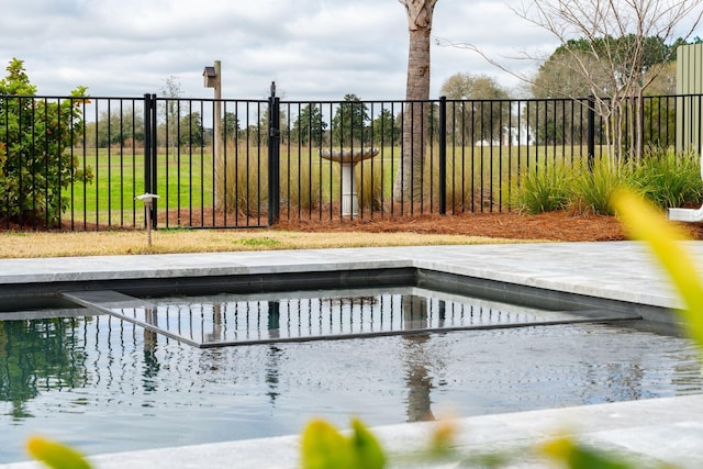 view of swimming pool featuring fence