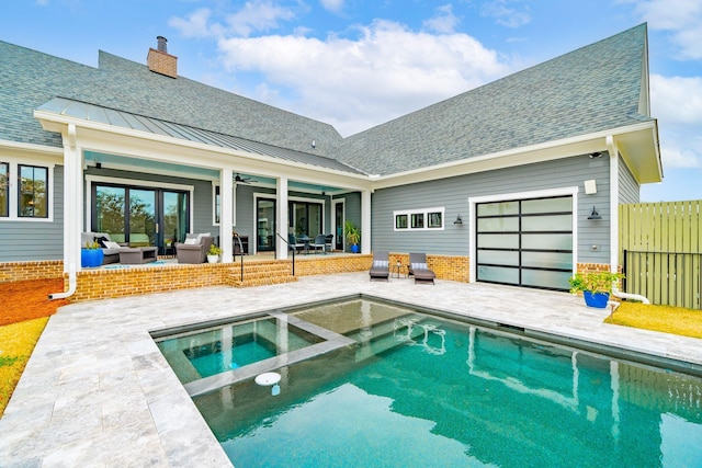 outdoor pool with a patio, an in ground hot tub, outdoor lounge area, fence, and a ceiling fan