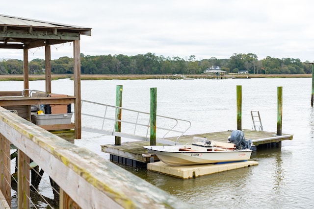 dock area featuring a forest view and a water view