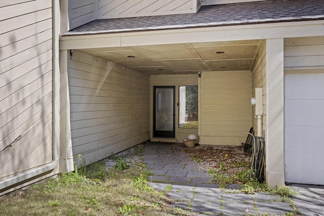 property entrance with a shingled roof