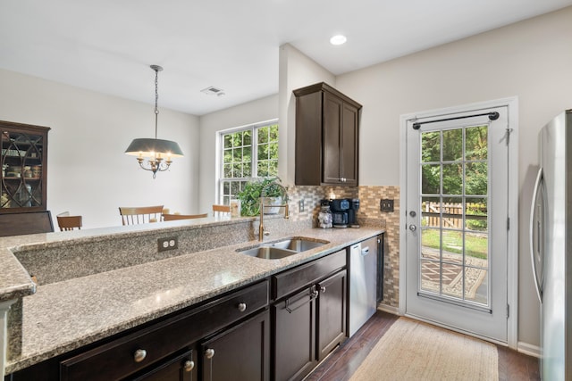826 Bibury Ct, Charleston, SC 29414 - kitchen featuring a sink, stainless steel appliances, a chandelier, dark brown cabinetry, and hanging light fixtures