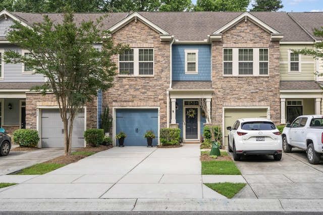 826 Bibury Ct, Charleston, SC 29414 - view of front of house with driveway, stone siding, and a garage