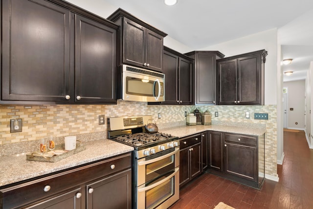 826 Bibury Ct, Charleston, SC 29414 - kitchen with stainless steel appliances, tasteful backsplash, dark wood-style floors, and dark brown cabinetry