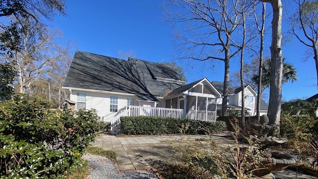 view of front of house with a patio area and a sunroom