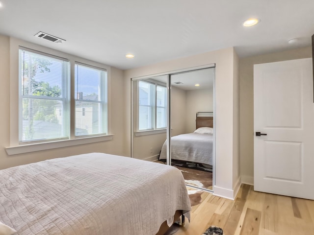 bedroom featuring light hardwood / wood-style floors and a closet