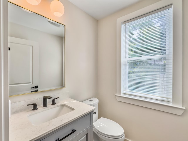 bathroom featuring vanity and toilet