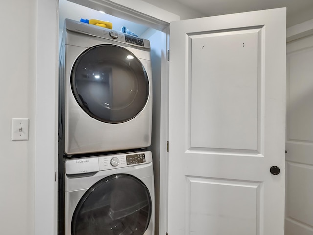 washroom with stacked washer / drying machine