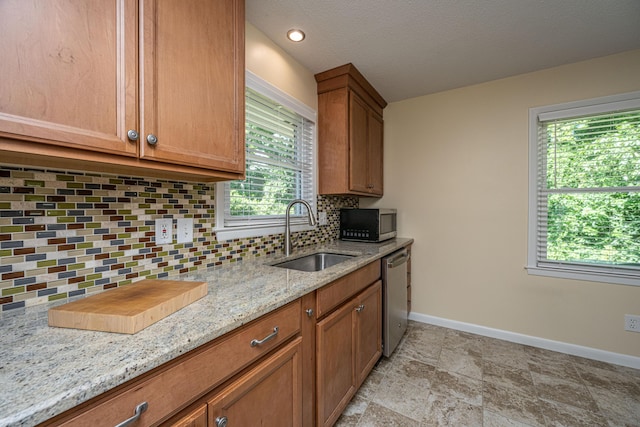 2847 Limestone Blvd, Charleston, SC 29414 - kitchen featuring appliances with stainless steel finishes, decorative backsplash, light stone countertops, and brown cabinets