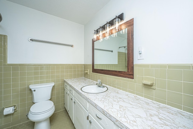 2847 Limestone Blvd, Charleston, SC 29414 - bathroom featuring vanity, tile walls, a wainscoted wall, and tile patterned floors