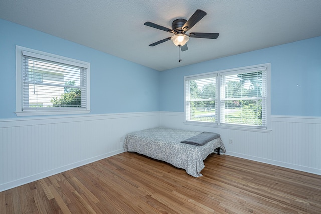 2847 Limestone Blvd, Charleston, SC 29414 - bedroom featuring a wainscoted wall, wood finished floors, and ceiling fan